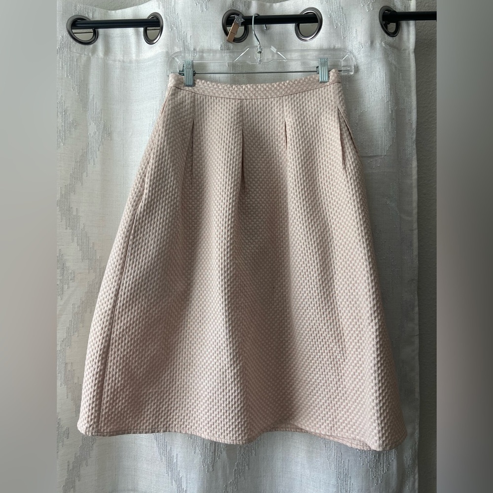 Full creamish-pink skirt.